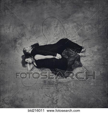 Stock Image - High angle view of sleeping couple holding hands. Fotosearch