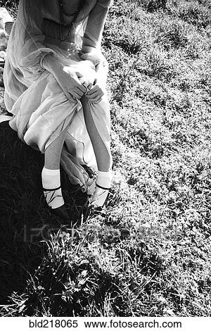 High angle view of woman sitting in grass View Large Photo Image Stock Photography - High angle view of woman sitting in grass. Fotosearch