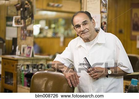 Hispanic barber standing in barbershop View Large Photo Image Stock Photograph - Hispanic barber standing in barbershop. Fotosearch