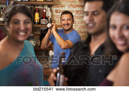 Hispanic bartender making drinks in bar View Large Photo Image Stock Image - Hispanic bartender making drinks in bar. Fotosearch