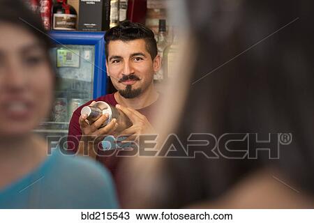 Hispanic bartender making drinks in bar View Large Photo Image Stock Image - Hispanic bartender making drinks in bar. Fotosearch