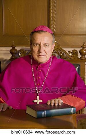 Hispanic bishop sitting with bible View Large Photo Image Picture - Hispanic bishop sitting with bible. Fotosearch