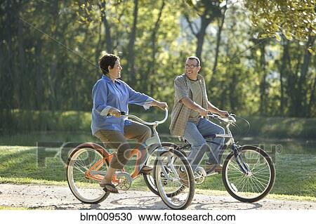 Stock Image - Hispanic couple riding bicycles. Fotosearch