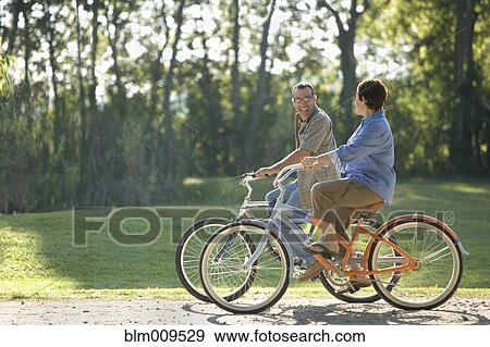 Stock Photo - Hispanic couple riding bicycles. Fotosearch