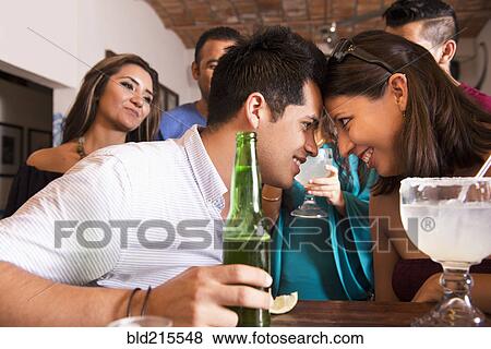 Hispanic couple touching foreheads in bar View Large Photo Image Stock Photo - Hispanic couple touching foreheads in bar. Fotosearch