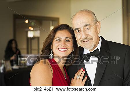 Stock Image - Hispanic father and daughter smiling at party. Fotosearch