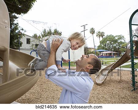 Hispanic father and son playing on playground View Large Photo Image Stock Photography - Hispanic father and son playing on playground. Fotosearch