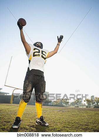 Hispanic football player cheering on football field View Large Photo Image Stock Photo - Hispanic football player cheering on football field. Fotosearch