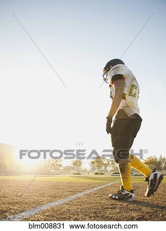 Hispanic football player walking on football field View Large Photo Image Stock Image - Hispanic football player walking on football field. Fotosearch