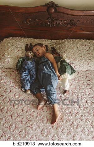 Hispanic girl napping on bed View Large Photo Image Stock Image - Hispanic girl napping on bed. Fotosearch