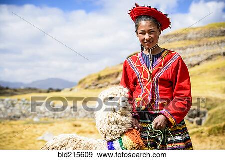 Stock Photo - Hispanic girl walking llama in rural landscape. Fotosearch