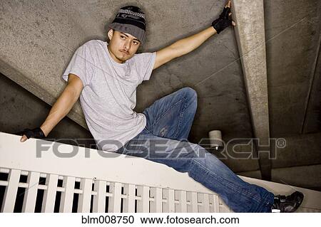 Hispanic man climbing over gate View Large Photo Image Stock Image - Hispanic man climbing over gate. Fotosearch