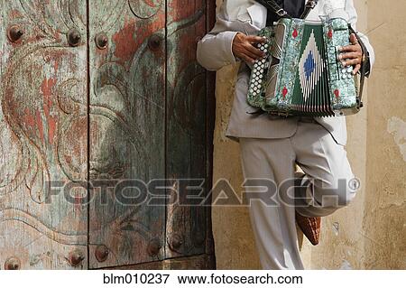 Stock Photo - Hispanic man playing accordion. Fotosearch