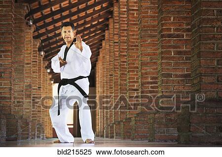 Hispanic man practicing martial arts in hallway View Large Photo Image Stock Photography - Hispanic man practicing martial arts in hallway. Fotosearch