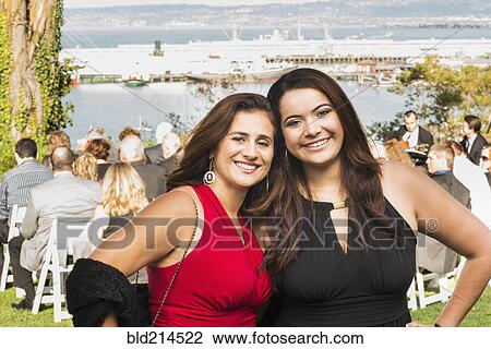 Hispanic mother and daughter smiling at wedding View Large Photo Image Stock Image - Hispanic mother and daughter smiling at wedding. Fotosearch