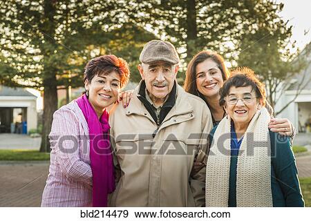 Stock Photo - Hispanic Multi-generation family smiling outdoors. Fotosearch