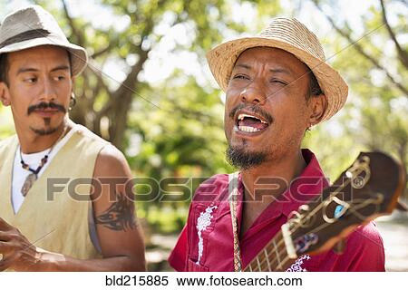 Stock Photography - Hispanic musicians performing in park. Fotosearch
