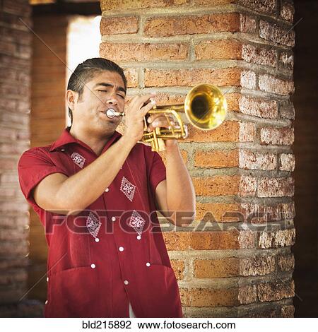 Hispanic musicians playing trumpet near brick wall View Large Photo Image Stock Image - Hispanic musicians playing trumpet near brick wall. Fotosearch