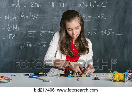 Hispanic student building vehicle in science class View Large Photo Image Stock Photograph - Hispanic student building vehicle in science class. Fotosearch