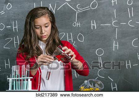 Stock Photo - Hispanic student doing experiment in science class. Fotosearch