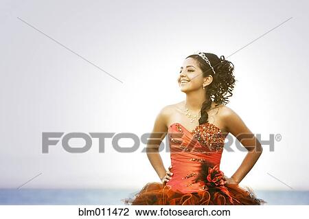 Stock Image - Hispanic teenager dressed for quinceanera. Fotosearch