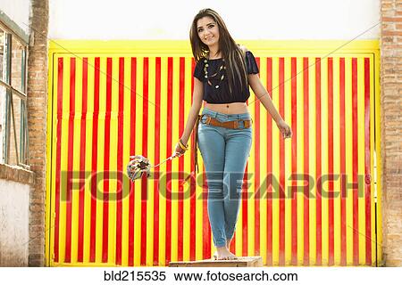 Hispanic woman balancing on stone wall View Large Photo Image Stock Photography - Hispanic woman balancing on stone wall. Fotosearch