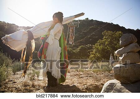 Hispanic woman carrying teepee in desert View Large Photo Image Picture - Hispanic woman carrying teepee in desert. Fotosearch