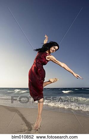 Hispanic woman dancing on beach View Large Photo Image Stock Image - Hispanic woman dancing on beach. Fotosearch
