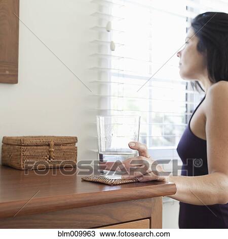 Stock Image - Hispanic woman drinking water. Fotosearch