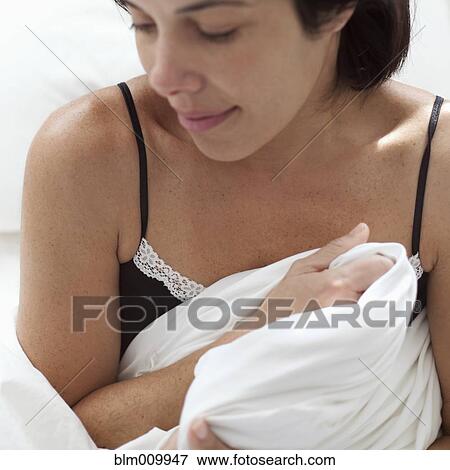 Hispanic woman holding blanket View Large Photo Image Stock Photo - Hispanic woman holding blanket. Fotosearch