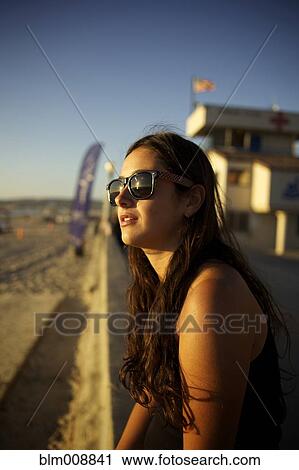 Hispanic woman in sunglasses enjoying beach View Large Photo Image Stock Image - Hispanic woman in sunglasses enjoying beach. Fotosearch