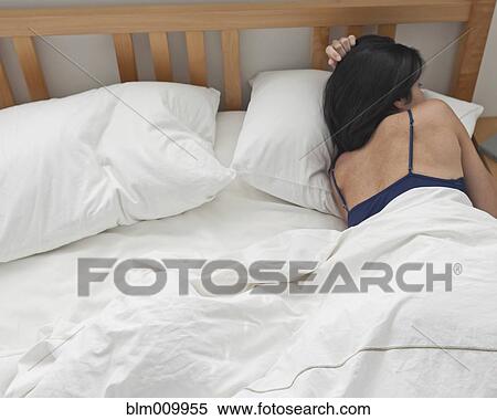 Hispanic woman laying in bed View Large Photo Image Stock Photography - Hispanic woman laying in bed. Fotosearch