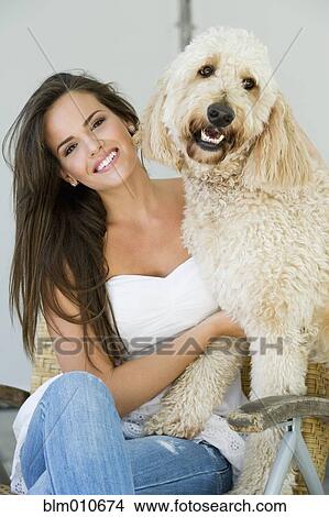 Hispanic woman sitting with dog View Large Photo Image Picture - Hispanic woman sitting with dog. Fotosearch
