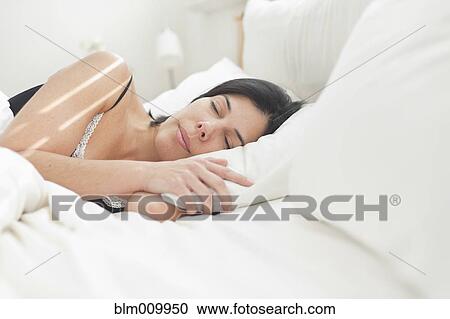 Hispanic woman sleeping in bed View Large Photo Image Stock Image - Hispanic woman sleeping in bed. Fotosearch