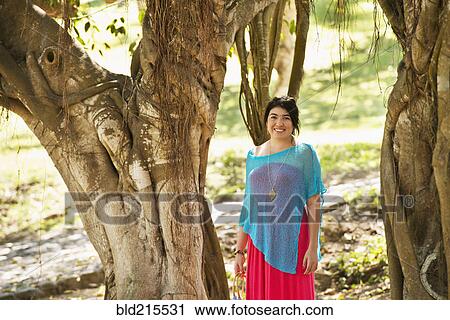 Hispanic woman smiling in jungle View Large Photo Image Stock Image - Hispanic woman smiling in jungle. Fotosearch