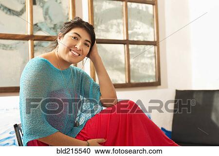 Hispanic woman smiling indoors View Large Photo Image Stock Image - Hispanic woman smiling indoors. Fotosearch