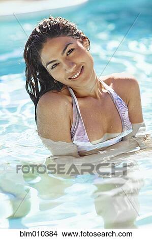 Hispanic woman swimming in swimming pool View Large Photo Image Picture - Hispanic woman swimming in swimming pool. Fotosearch