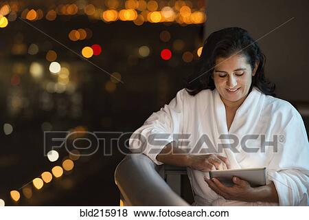 Hispanic woman using digital tablet on hotel balcony View Large Photo Image Stock Photo - Hispanic woman using digital tablet on hotel balcony. Fotosearch
