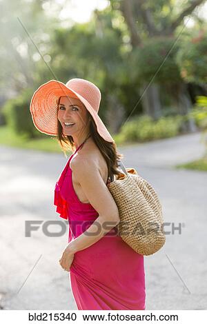 Stock Image - Hispanic woman walking on road. Fotosearch