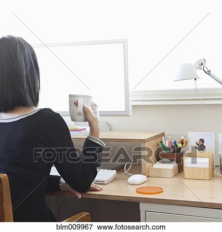 Hispanic woman working in home office View Large Photo Image Stock Photo - Hispanic woman working in home office. Fotosearch
