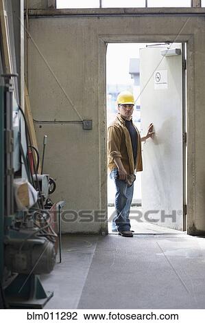 Hispanic worker entering factory door View Large Photo Image Stock Image - Hispanic worker entering factory door. Fotosearch