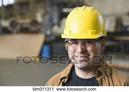 Hispanic worker in hard-hat and protective eyewear View Large Photo Image Stock Image - Hispanic worker in hard-hat and protective eyewear. Fotosearch