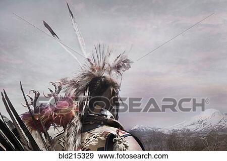 Stock Photo - Hunter wearing traditional native headdress. Fotosearch