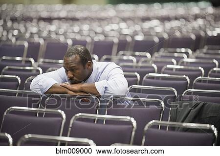 Impatient Black businessman waiting in empty conference center View Large Photo Image Stock Image - Impatient Black businessman waiting in empty conference center. Fotosearch