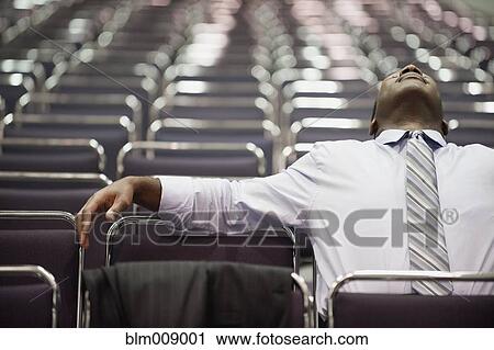 Impatient Black businessman waiting in empty conference center View Large Photo Image Stock Image - Impatient Black businessman waiting in empty conference center. Fotosearch