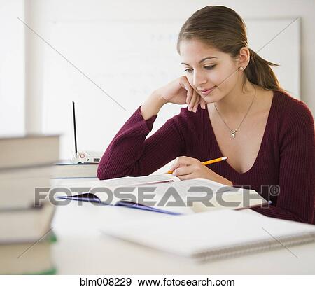 Indian student studying textbook View Large Photo Image Stock Photo - Indian student studying textbook. Fotosearch