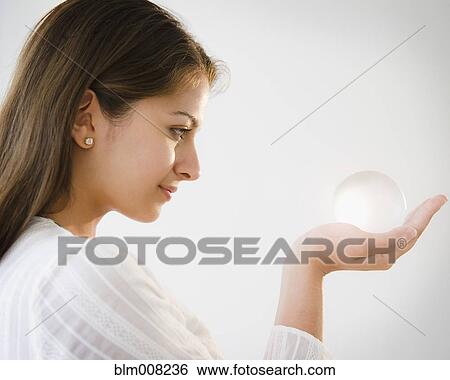 Indian woman looking at glass ball View Large Photo Image Stock Photograph - Indian woman looking at glass ball. Fotosearch