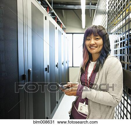 Japanese businesswoman using cell phone in office technology room View Large Photo Image Stock Image - Japanese businesswoman using cell phone in office technology room. Fotosearch