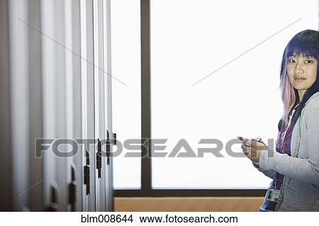 Picture - Japanese businesswoman working in office technology room. Fotosearch