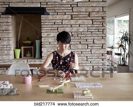 Picture - Japanese woman wrapping gifts. Fotosearch